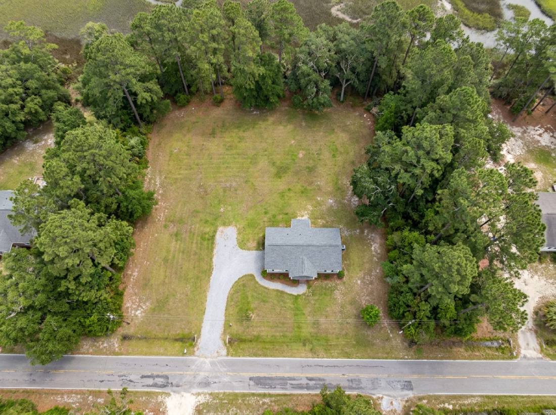 AI-generated sample aerial of a one-acre lot with the lot lines outlined in gold